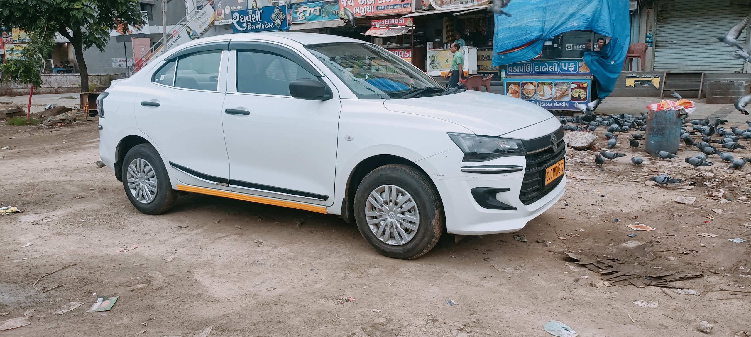Maruti Suzuki Swift Dzire AC taxi from Ahmedabad Kalupur Railway Station to Junagadh